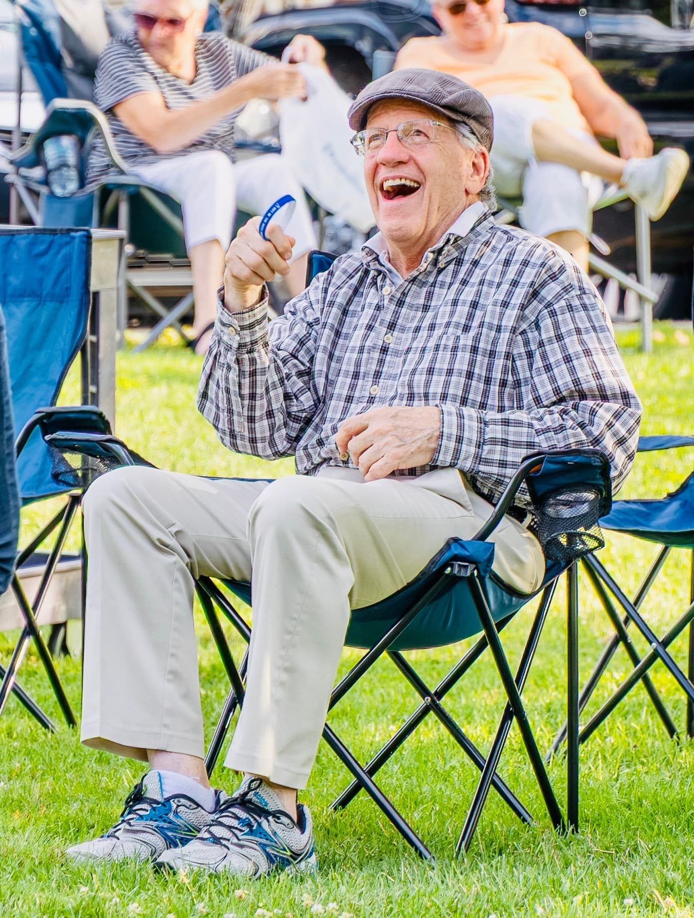 An audience member laughing in his lawn chair during the show