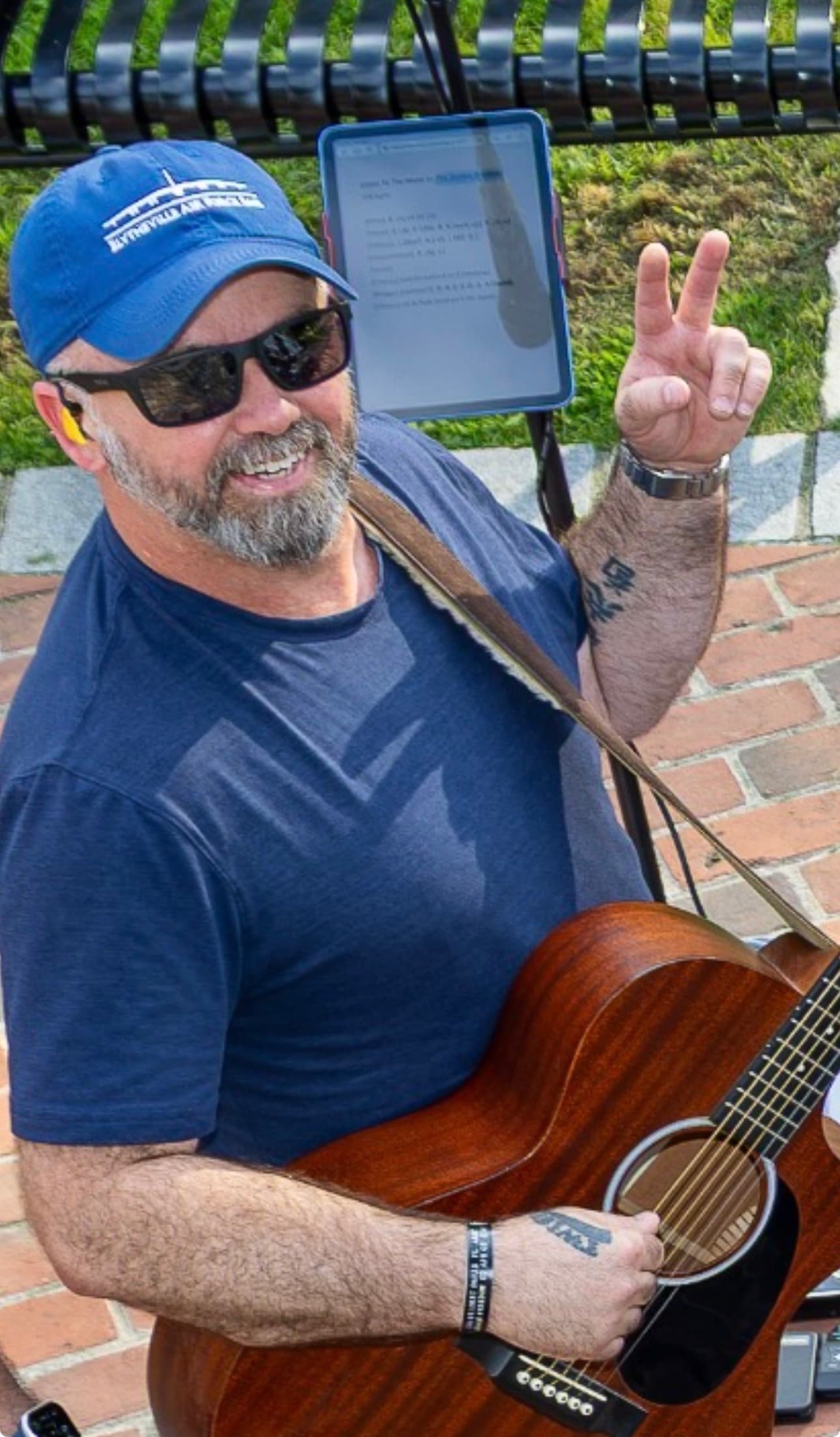 Bassist flashing a peace sign between songs at the gazebo show