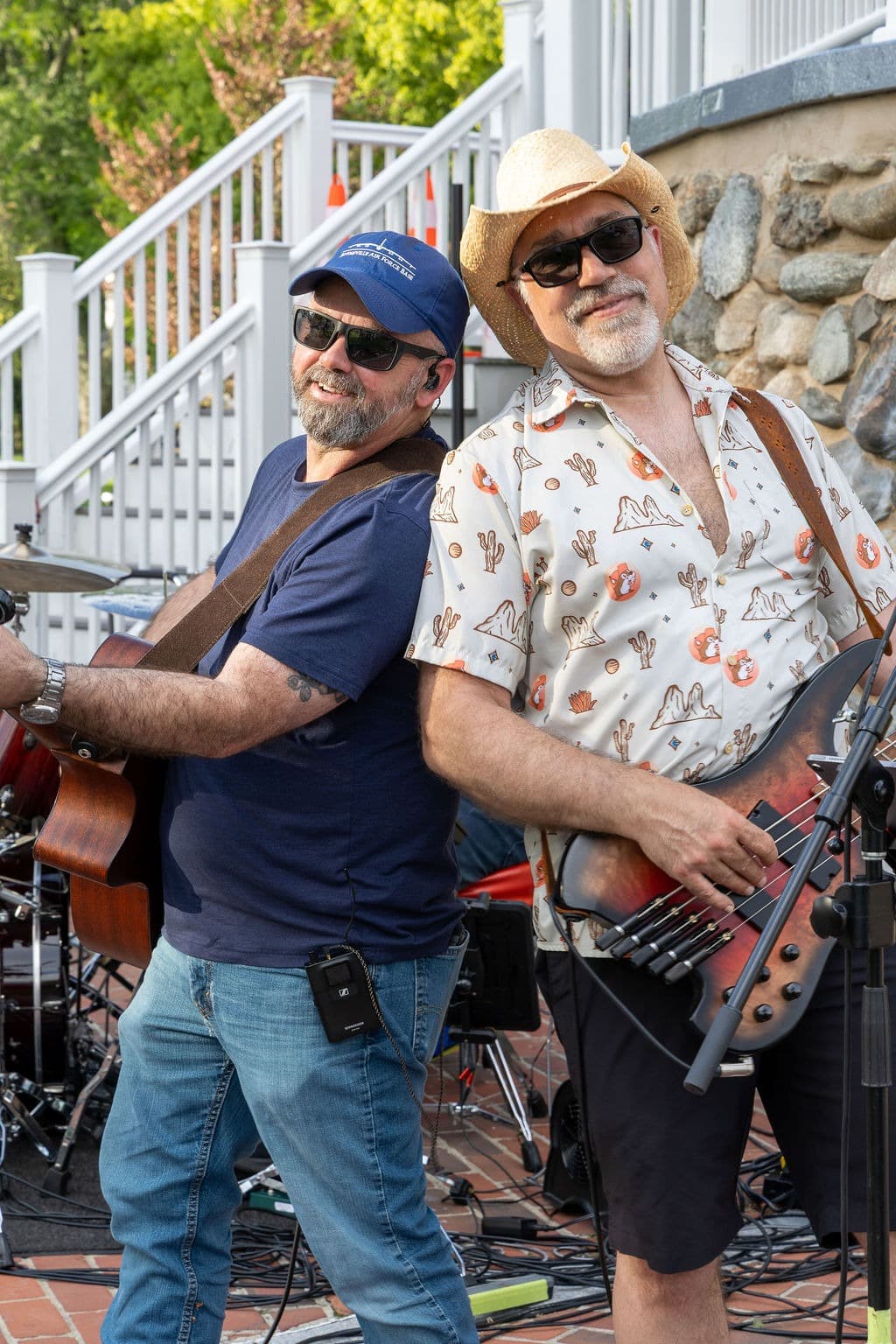Guitarist and bassist posing back-to-back before a show